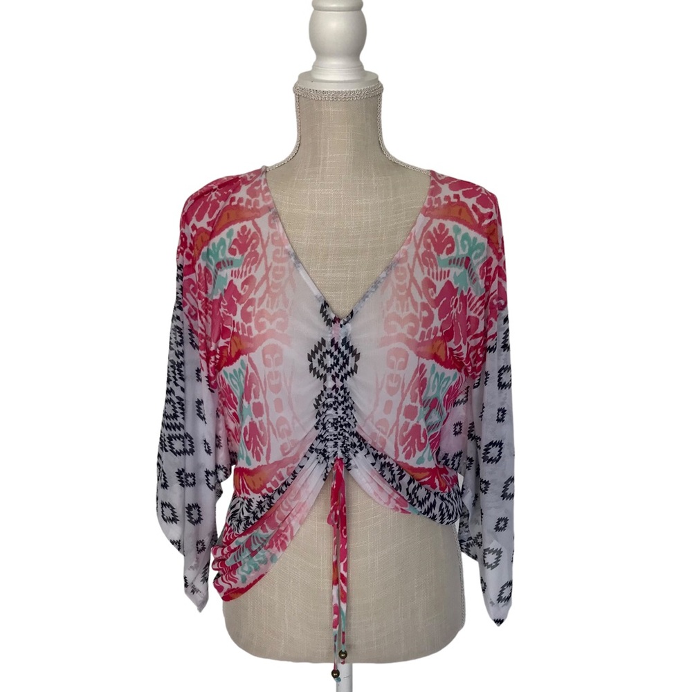 Mesh Bebe top in size small which is cropped in the front and long in the back